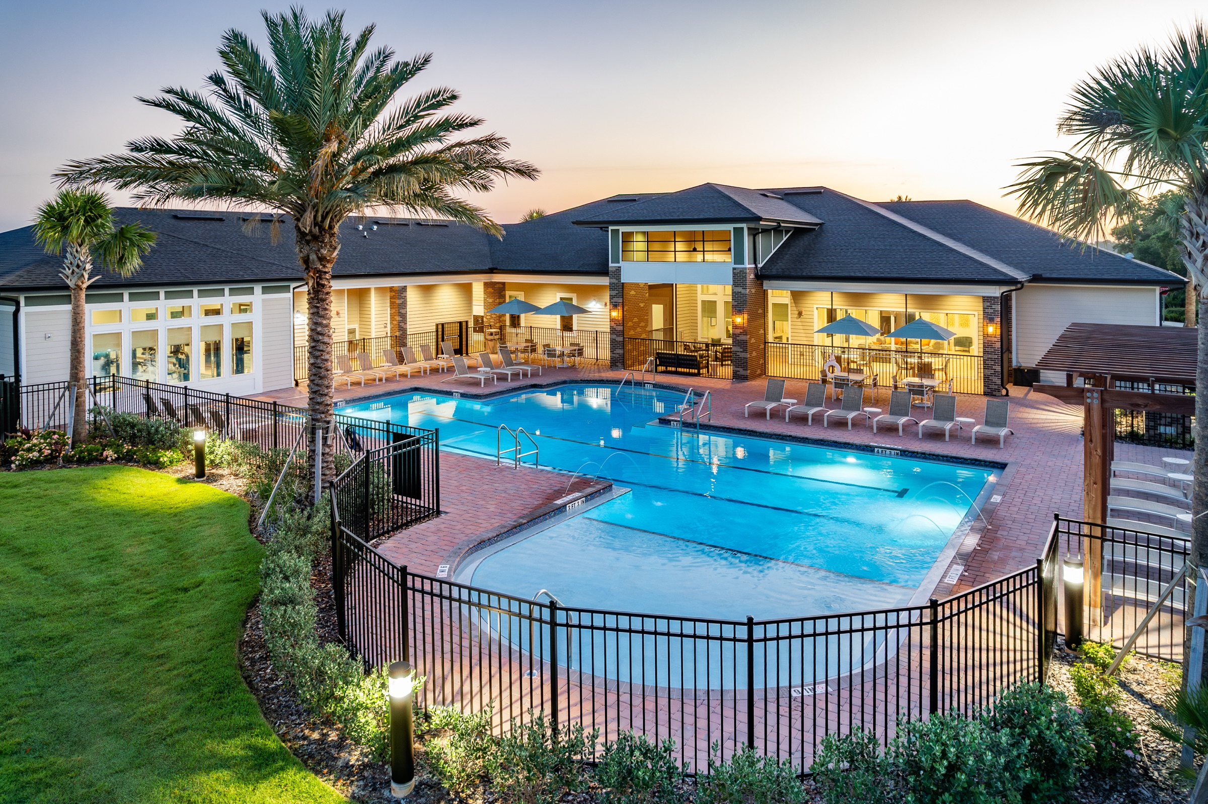 Multifamily pool and clubhouse at twilight